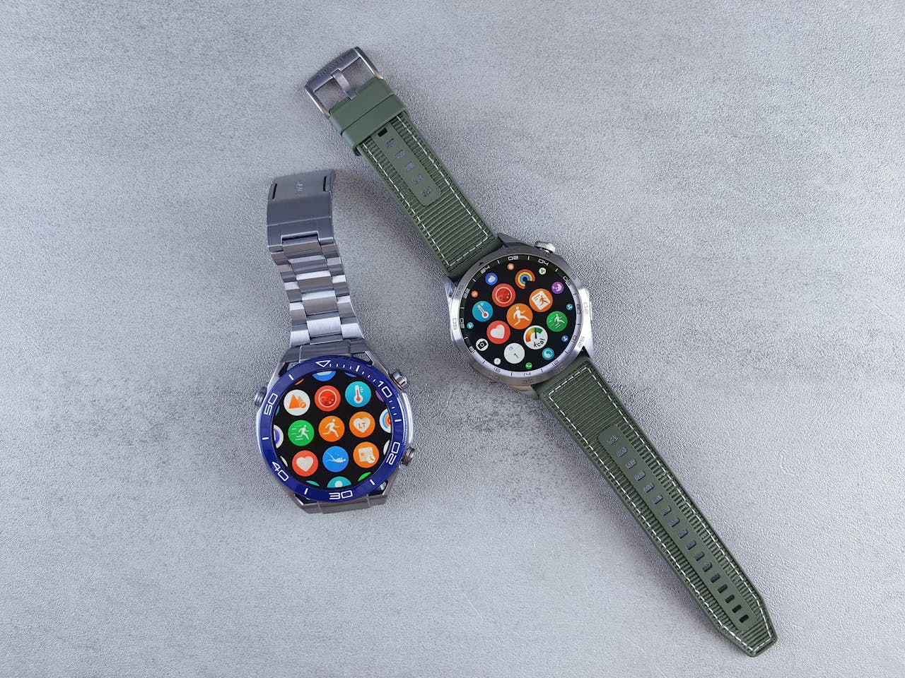 Close-up of two smartwatches on a gray background highlighting design and technology.